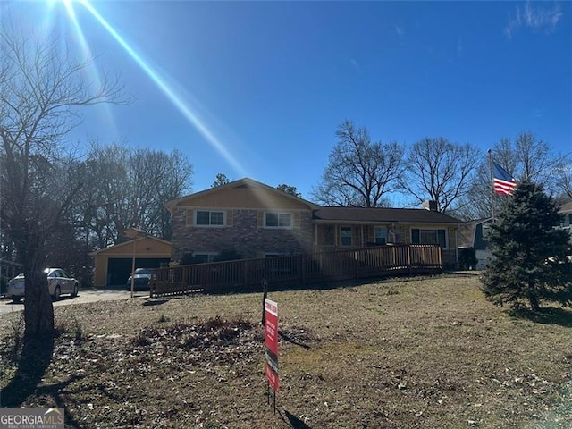 back of house featuring a garage and an outbuilding