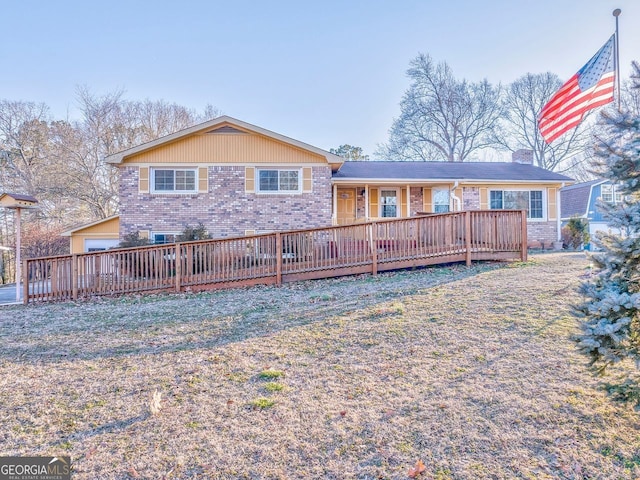 back of property featuring a lawn and a wooden deck