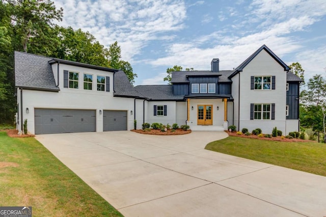 view of front of property with a garage, a front lawn, and french doors