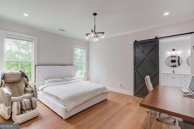 bedroom featuring multiple windows, a chandelier, light wood-type flooring, crown molding, and a barn door