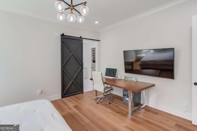 office area with a chandelier, crown molding, a barn door, and wood-type flooring