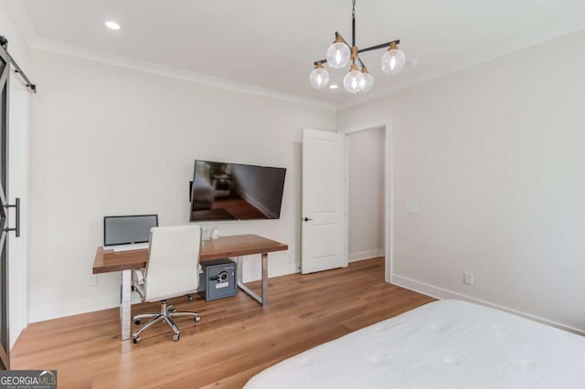 bedroom featuring hardwood / wood-style flooring, crown molding, a chandelier, and a barn door