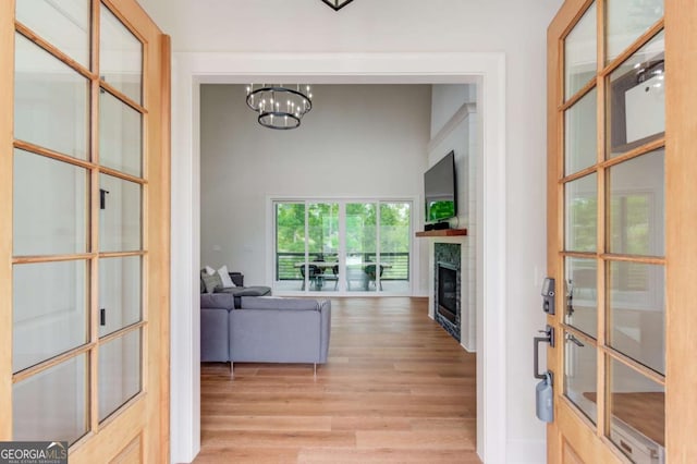 interior space with light wood-type flooring and a chandelier