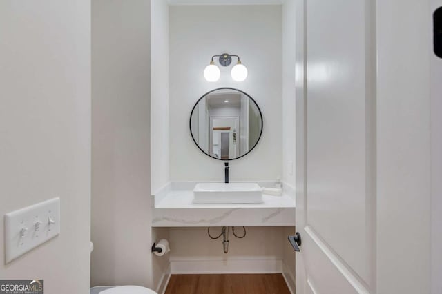 bathroom with hardwood / wood-style flooring and sink