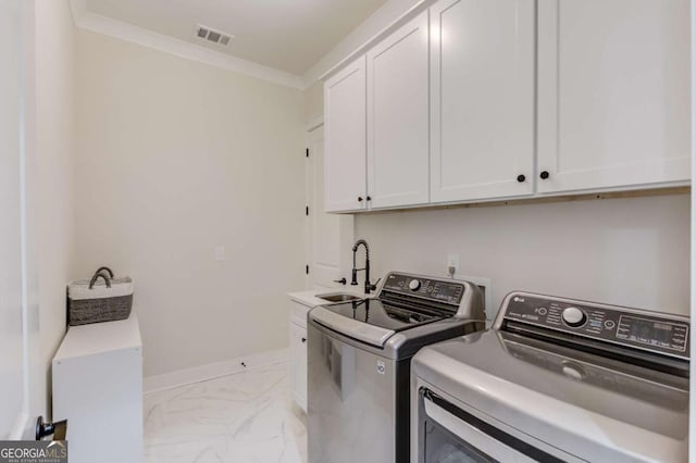 washroom with washer and dryer, cabinets, crown molding, and sink