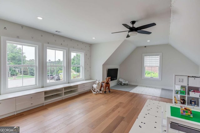 additional living space with light wood-type flooring, ceiling fan, and vaulted ceiling