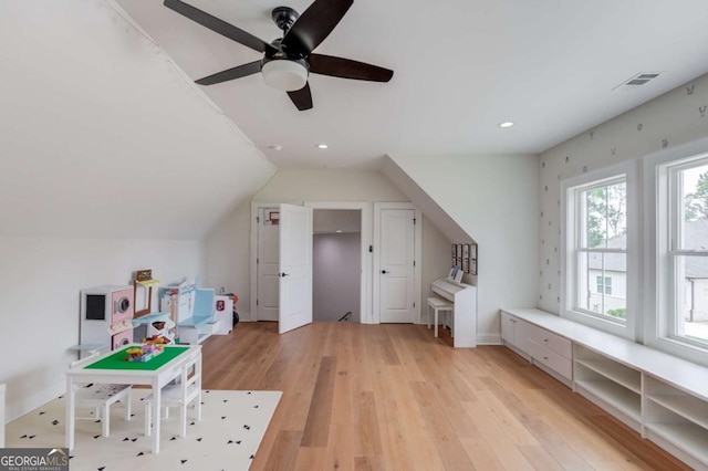 playroom featuring ceiling fan, light hardwood / wood-style floors, and lofted ceiling