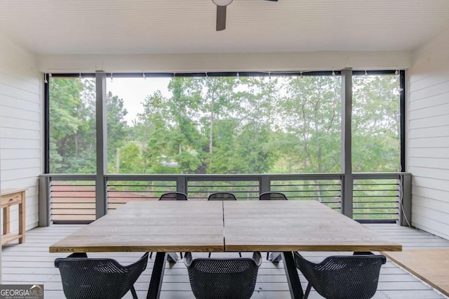 sunroom featuring ceiling fan