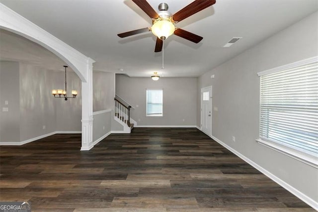 unfurnished room featuring dark wood-type flooring and ceiling fan with notable chandelier