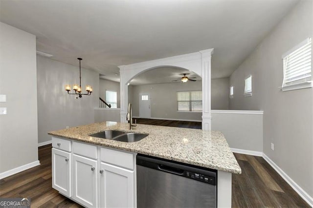 kitchen with light stone counters, dishwasher, sink, and white cabinets