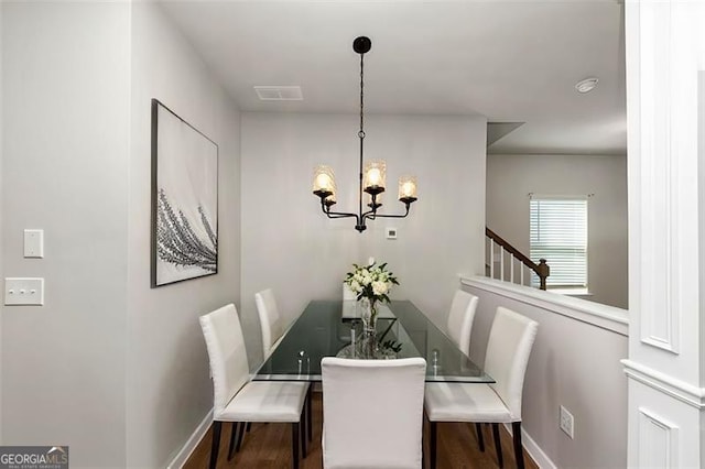 dining room featuring hardwood / wood-style floors and a notable chandelier