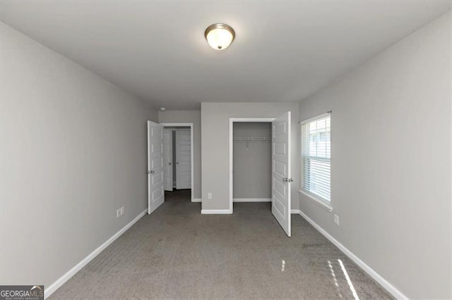 unfurnished bedroom with carpet floors and a closet