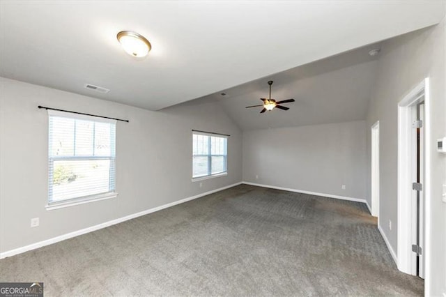 carpeted spare room with vaulted ceiling and ceiling fan