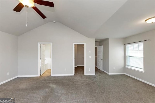 unfurnished bedroom with vaulted ceiling, ensuite bathroom, carpet flooring, a spacious closet, and ceiling fan