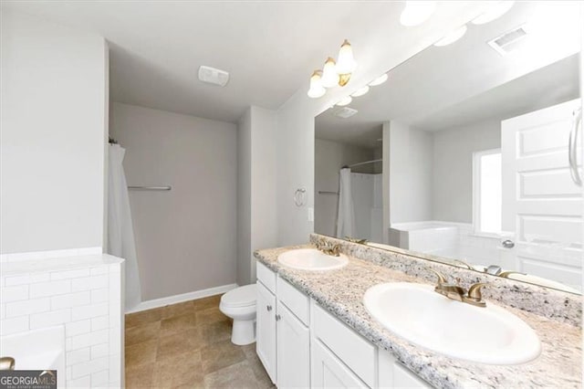 bathroom featuring vanity, a tub, and toilet