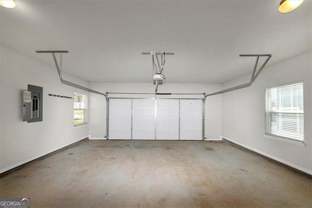 garage with a garage door opener and electric panel