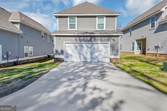 front facade featuring a garage and a front lawn