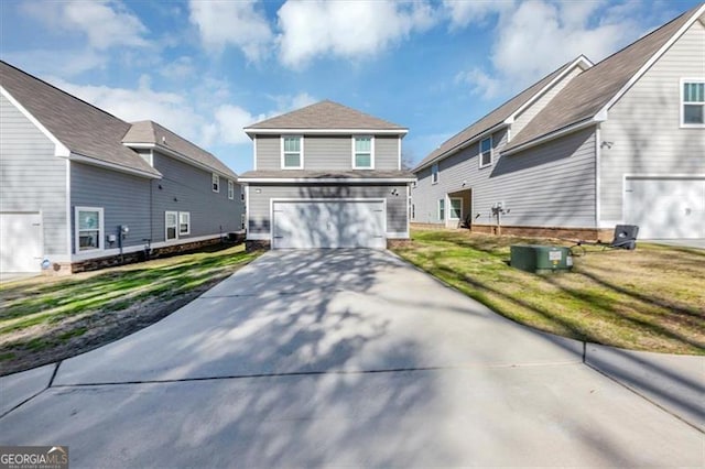 view of front property featuring a garage and a front yard