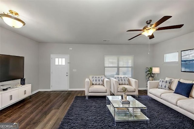 living room with dark wood-type flooring and ceiling fan