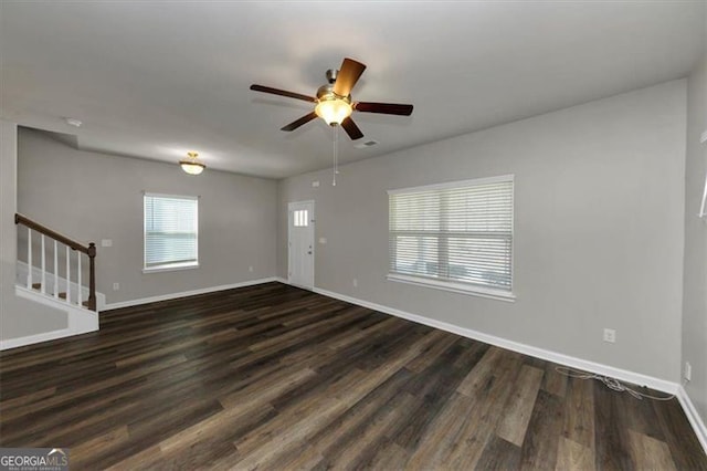 spare room featuring dark wood-type flooring and ceiling fan