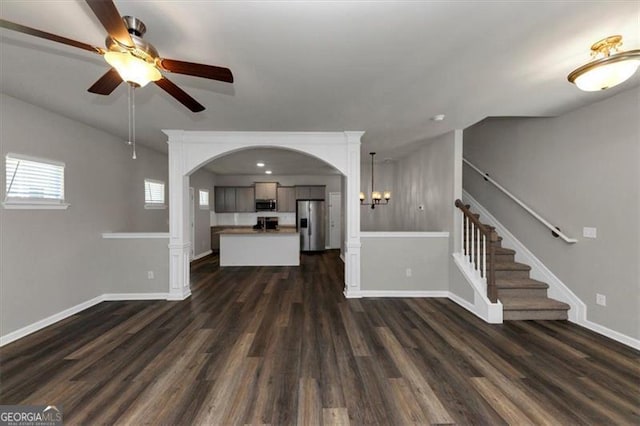 unfurnished living room featuring dark hardwood / wood-style floors and ceiling fan