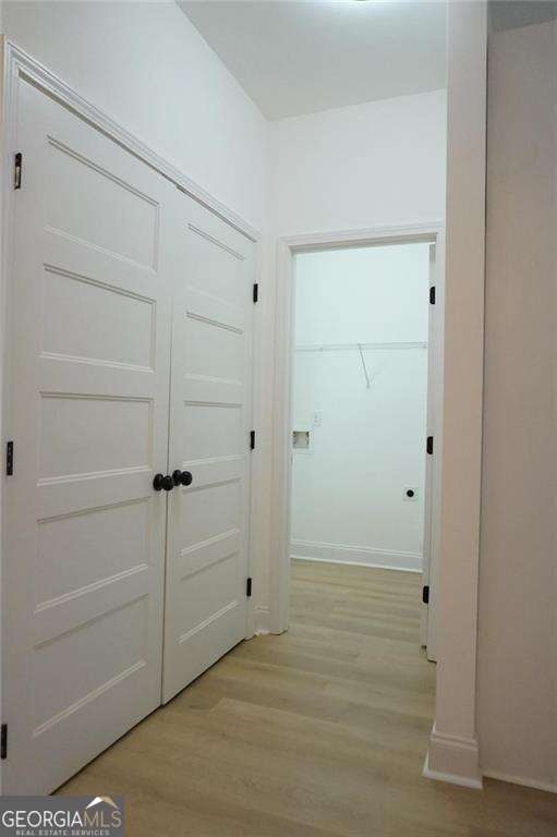 hallway with light wood-type flooring