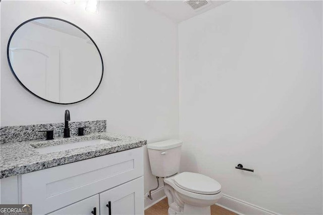 bathroom featuring toilet and vanity