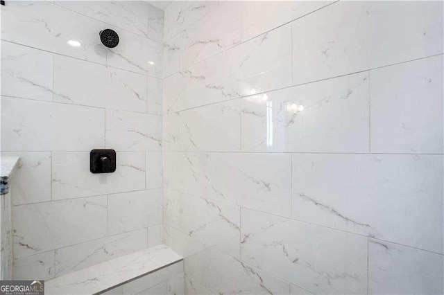 bathroom with a tile shower