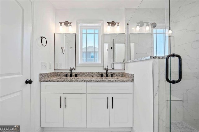 bathroom featuring walk in shower and vanity