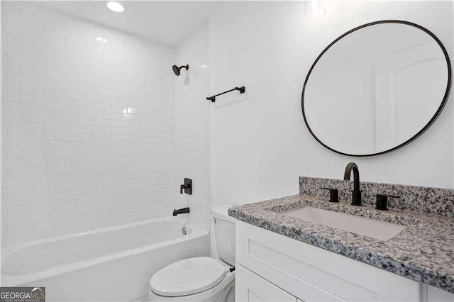 full bathroom with toilet, vanity, and tiled shower / bath combo