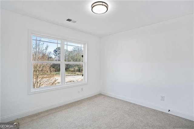 empty room with a healthy amount of sunlight and carpet floors