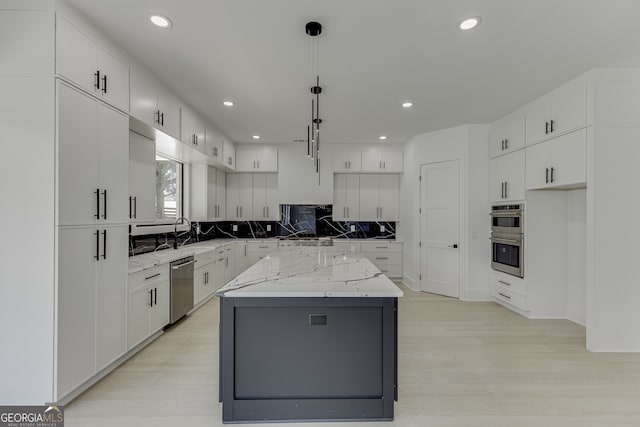 kitchen featuring pendant lighting, white cabinetry, and a kitchen island