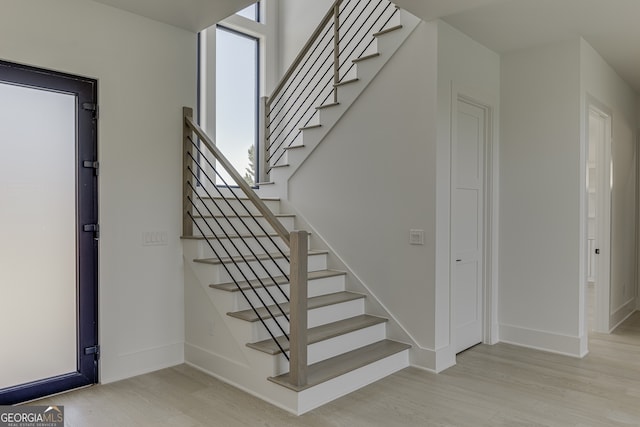 stairway with hardwood / wood-style flooring