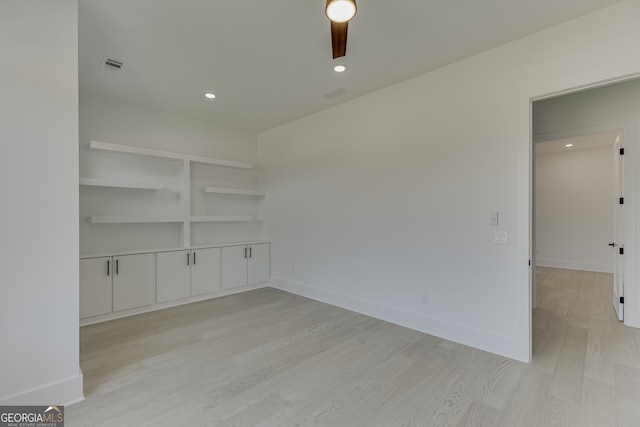 empty room featuring ceiling fan and light hardwood / wood-style floors