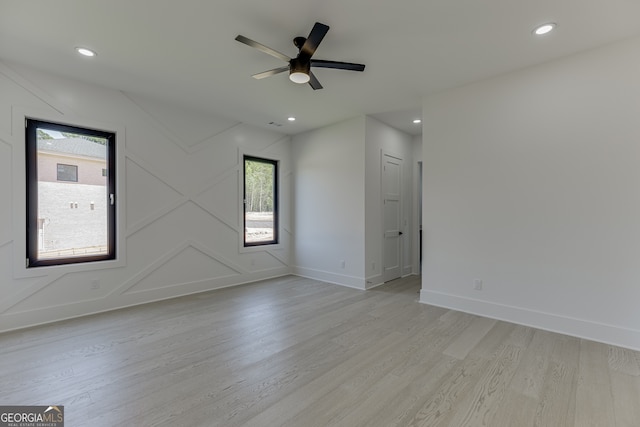 unfurnished room with ceiling fan, light hardwood / wood-style floors, and a wealth of natural light