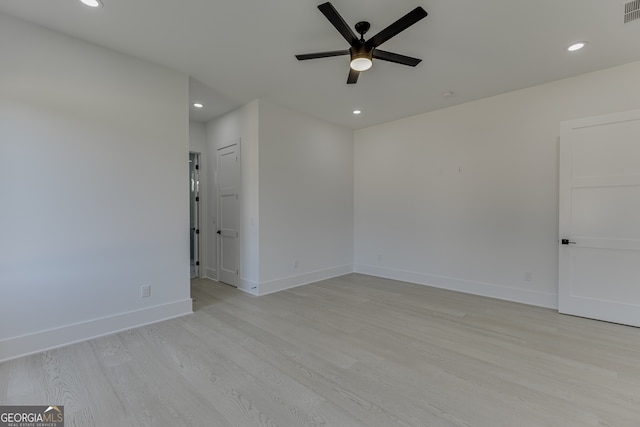 spare room featuring ceiling fan and light hardwood / wood-style floors