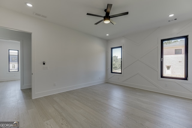 spare room featuring ceiling fan and light hardwood / wood-style floors