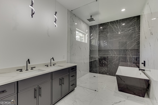 bathroom with a tile shower and vanity