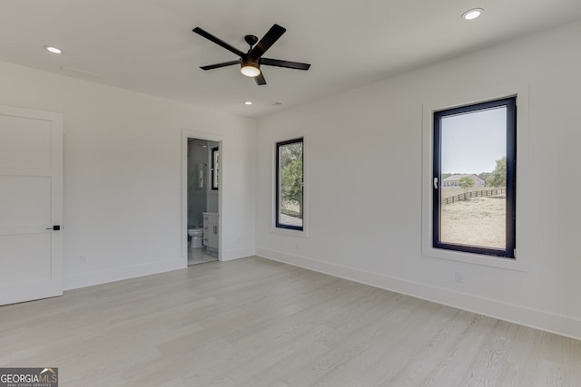 spare room with light wood-type flooring and ceiling fan