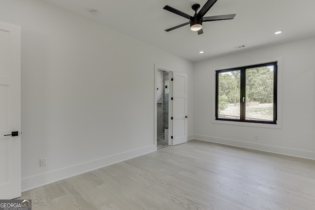 empty room featuring ceiling fan and light hardwood / wood-style flooring