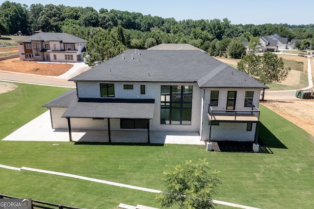 rear view of property with a patio area and a yard