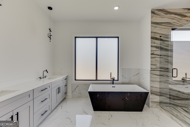 bathroom featuring vanity and shower with separate bathtub