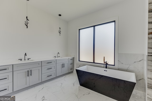 bathroom with tile walls, vanity, and a bathing tub