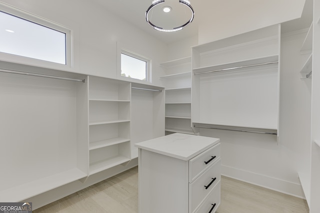 walk in closet with light wood-type flooring