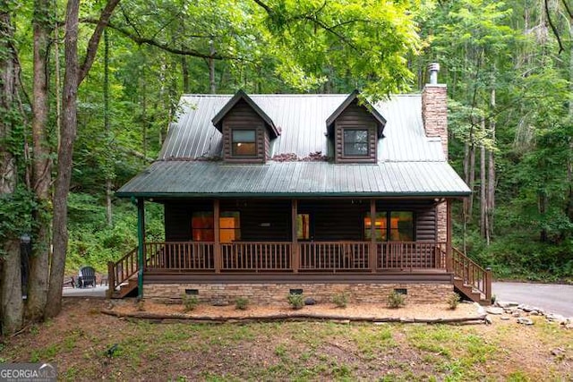 log home featuring a porch