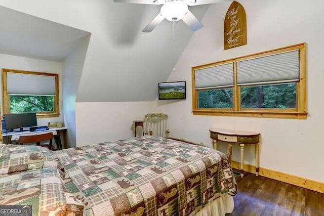 bedroom with ceiling fan, vaulted ceiling, and dark wood-type flooring