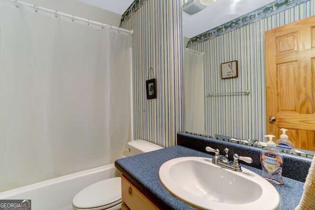 full bathroom with toilet, vanity, and shower / tub combo with curtain