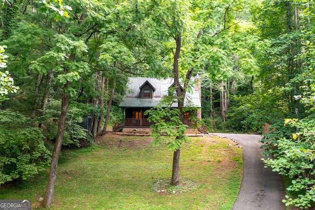 obstructed view of property featuring a front yard and a porch