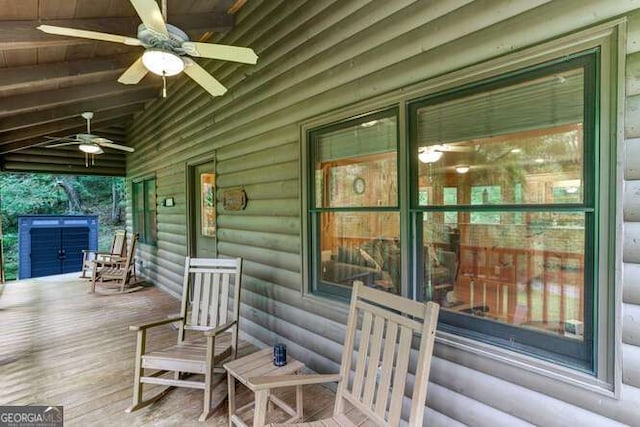 wooden terrace featuring ceiling fan and covered porch