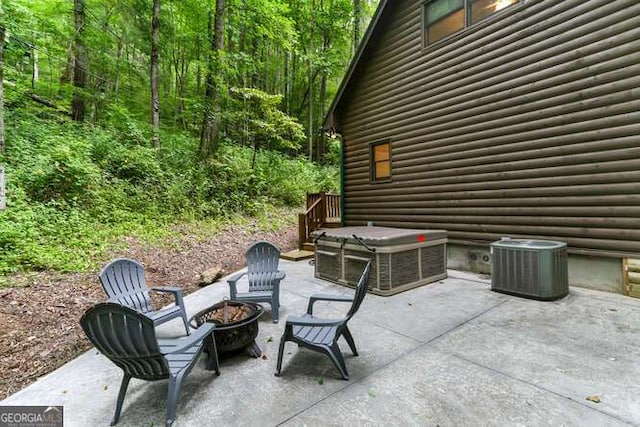 view of patio featuring central AC and an outdoor fire pit